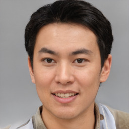 Joyful asian young-adult male with short  brown hair and brown eyes