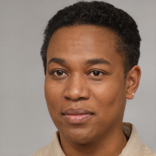Joyful black young-adult male with short  black hair and brown eyes