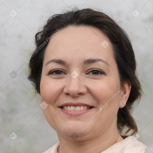 Joyful white adult female with medium  brown hair and brown eyes