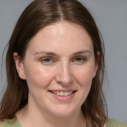 Joyful white young-adult female with medium  brown hair and blue eyes