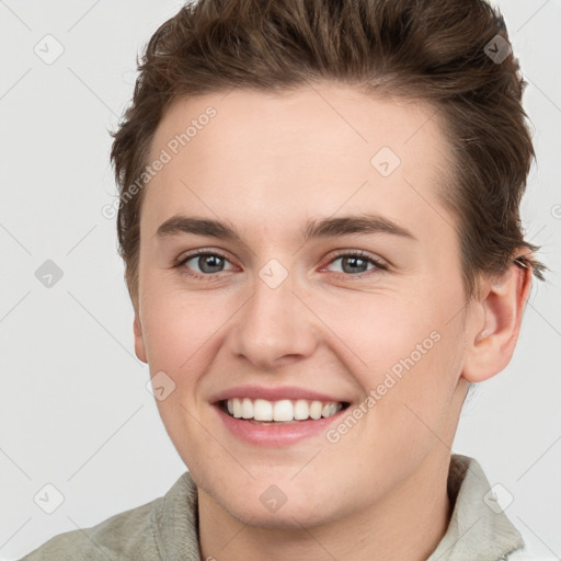 Joyful white young-adult female with short  brown hair and grey eyes