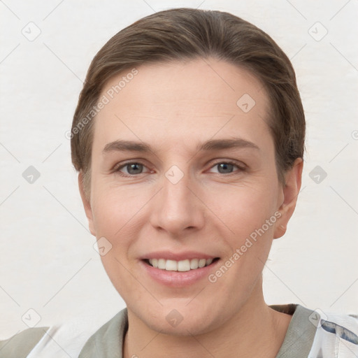 Joyful white young-adult female with short  brown hair and grey eyes