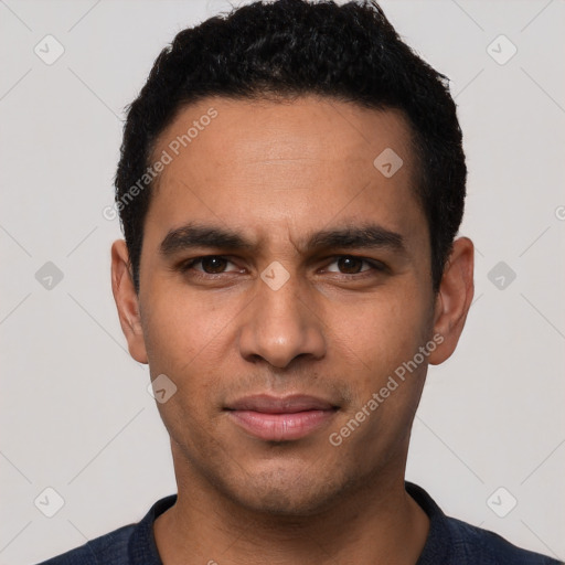 Joyful latino young-adult male with short  black hair and brown eyes