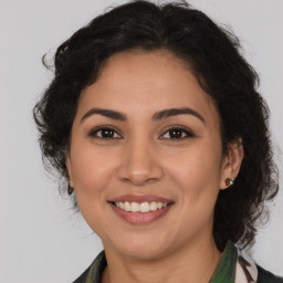 Joyful latino young-adult female with medium  brown hair and brown eyes