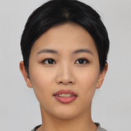 Joyful asian young-adult female with short  black hair and brown eyes