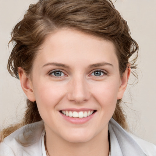 Joyful white young-adult female with medium  brown hair and blue eyes