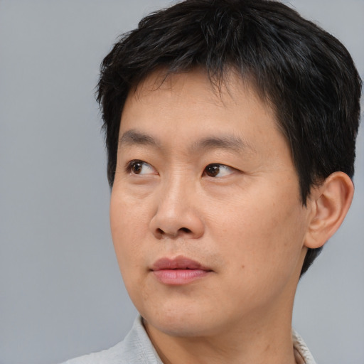 Neutral asian adult male with short  black hair and brown eyes