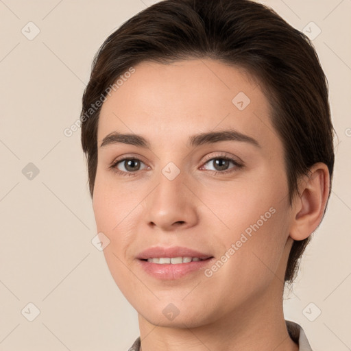 Joyful white young-adult female with short  brown hair and brown eyes