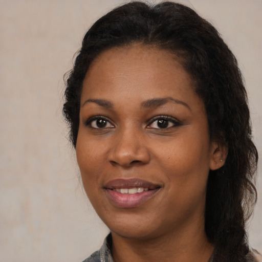 Joyful black young-adult female with medium  black hair and brown eyes