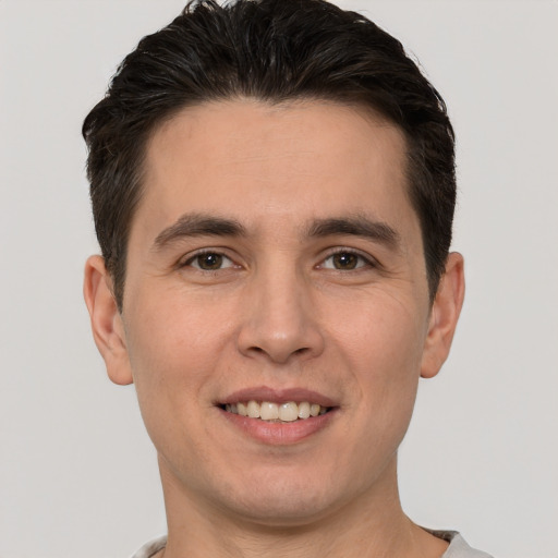 Joyful white young-adult male with short  brown hair and brown eyes