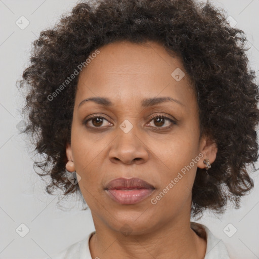 Joyful black adult female with medium  brown hair and brown eyes