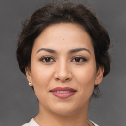 Joyful white adult female with medium  brown hair and brown eyes