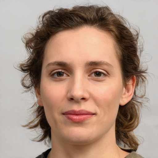 Joyful white young-adult female with medium  brown hair and green eyes