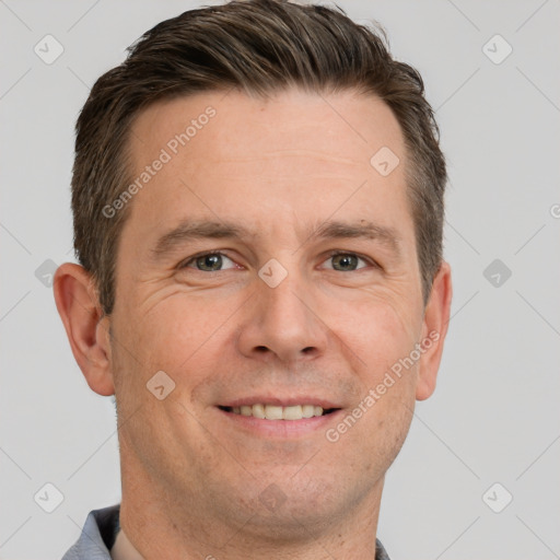 Joyful white adult male with short  brown hair and grey eyes