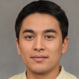 Joyful asian young-adult male with short  black hair and brown eyes