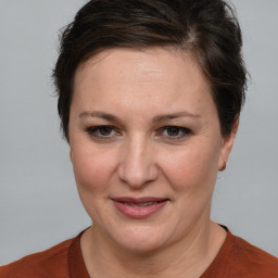 Joyful white adult female with short  brown hair and brown eyes