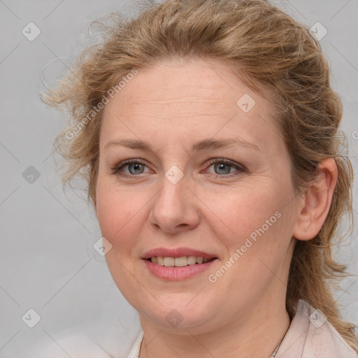 Joyful white adult female with medium  brown hair and blue eyes