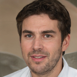 Joyful white adult male with short  brown hair and brown eyes