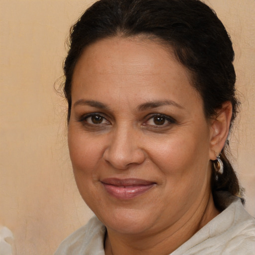 Joyful white adult female with medium  brown hair and brown eyes