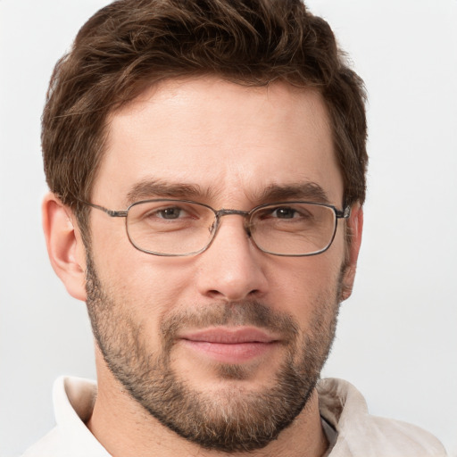 Joyful white young-adult male with short  brown hair and grey eyes