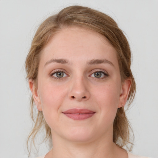 Joyful white young-adult female with medium  brown hair and blue eyes