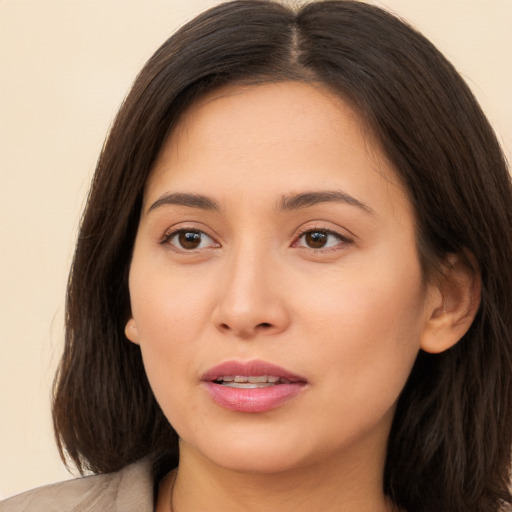 Joyful white young-adult female with long  brown hair and brown eyes