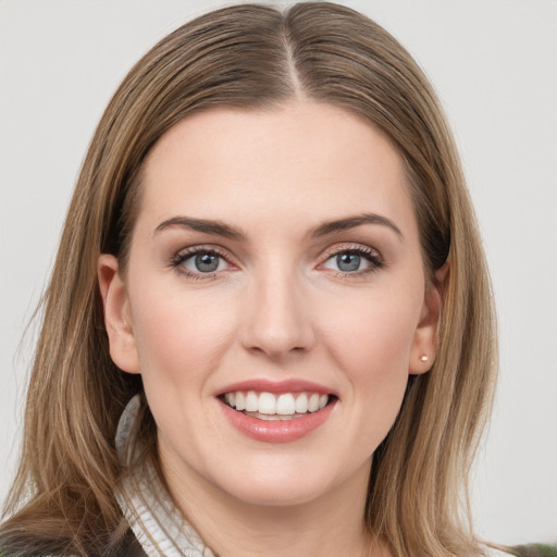 Joyful white young-adult female with long  brown hair and grey eyes