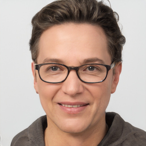 Joyful white adult female with short  brown hair and grey eyes