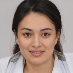 Joyful latino young-adult female with medium  brown hair and brown eyes