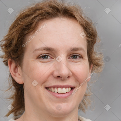 Joyful white adult female with medium  brown hair and grey eyes