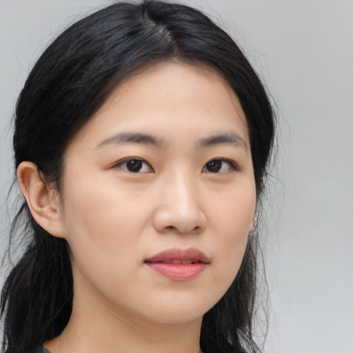 Joyful asian young-adult female with long  brown hair and brown eyes