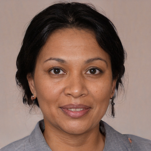 Joyful white adult female with medium  brown hair and brown eyes