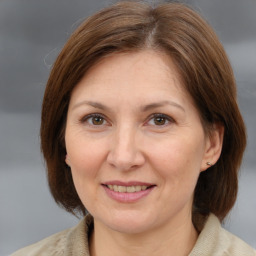 Joyful white adult female with medium  brown hair and brown eyes