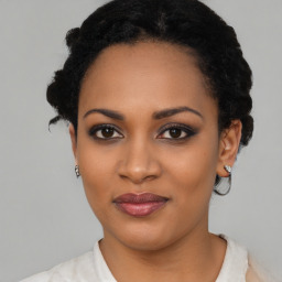Joyful black young-adult female with short  black hair and brown eyes