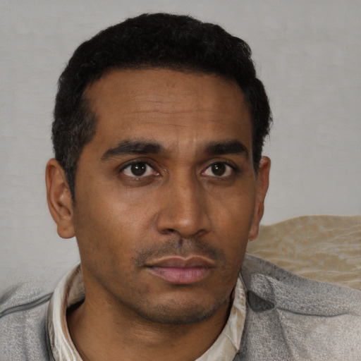 Neutral black young-adult male with short  black hair and brown eyes
