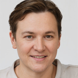 Joyful white adult male with short  brown hair and grey eyes