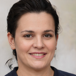 Joyful white young-adult female with medium  brown hair and brown eyes