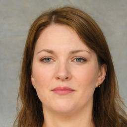 Joyful white young-adult female with long  brown hair and green eyes