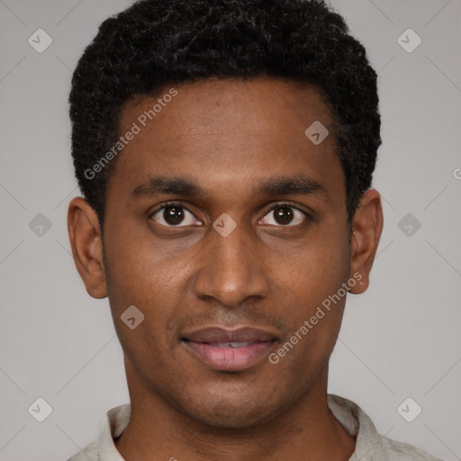 Joyful black young-adult male with short  brown hair and brown eyes