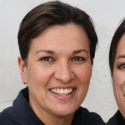 Joyful white adult female with short  brown hair and brown eyes