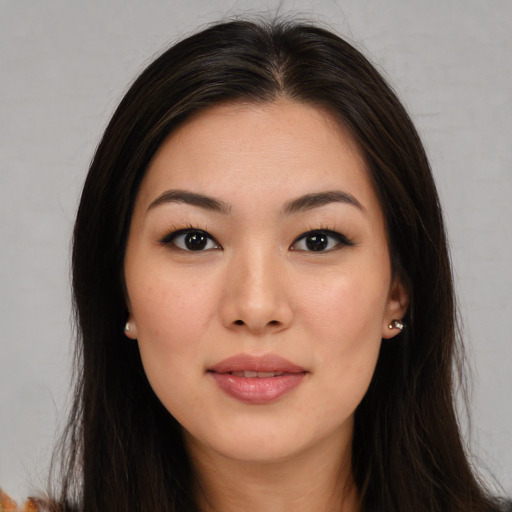 Joyful asian young-adult female with long  brown hair and brown eyes