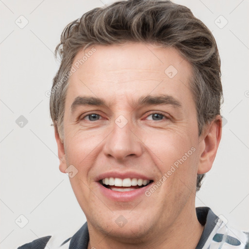 Joyful white adult male with short  brown hair and grey eyes