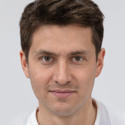 Joyful white adult male with short  brown hair and brown eyes