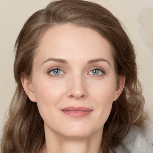 Joyful white young-adult female with medium  brown hair and blue eyes