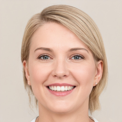 Joyful white young-adult female with medium  brown hair and green eyes