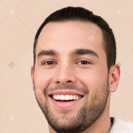 Joyful white young-adult male with short  black hair and brown eyes