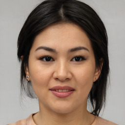 Joyful asian young-adult female with medium  brown hair and brown eyes