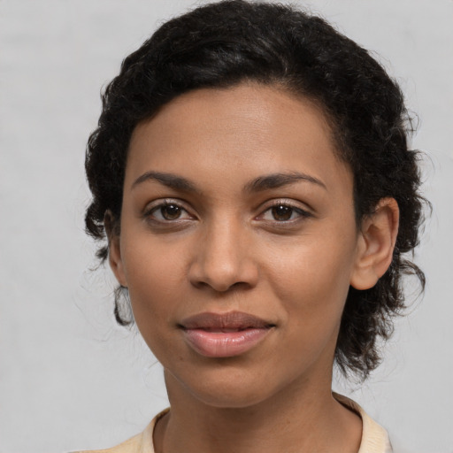 Joyful latino young-adult female with medium  black hair and brown eyes