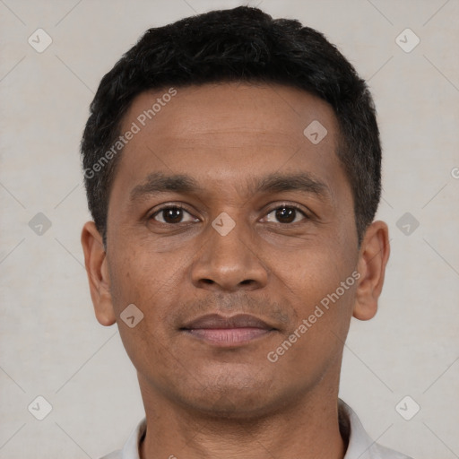 Joyful black young-adult male with short  brown hair and brown eyes