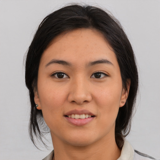 Joyful asian young-adult female with medium  black hair and brown eyes